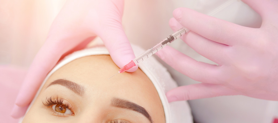 Woman receiving injection in forehead