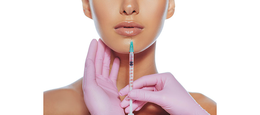 Woman getting lip filler injection